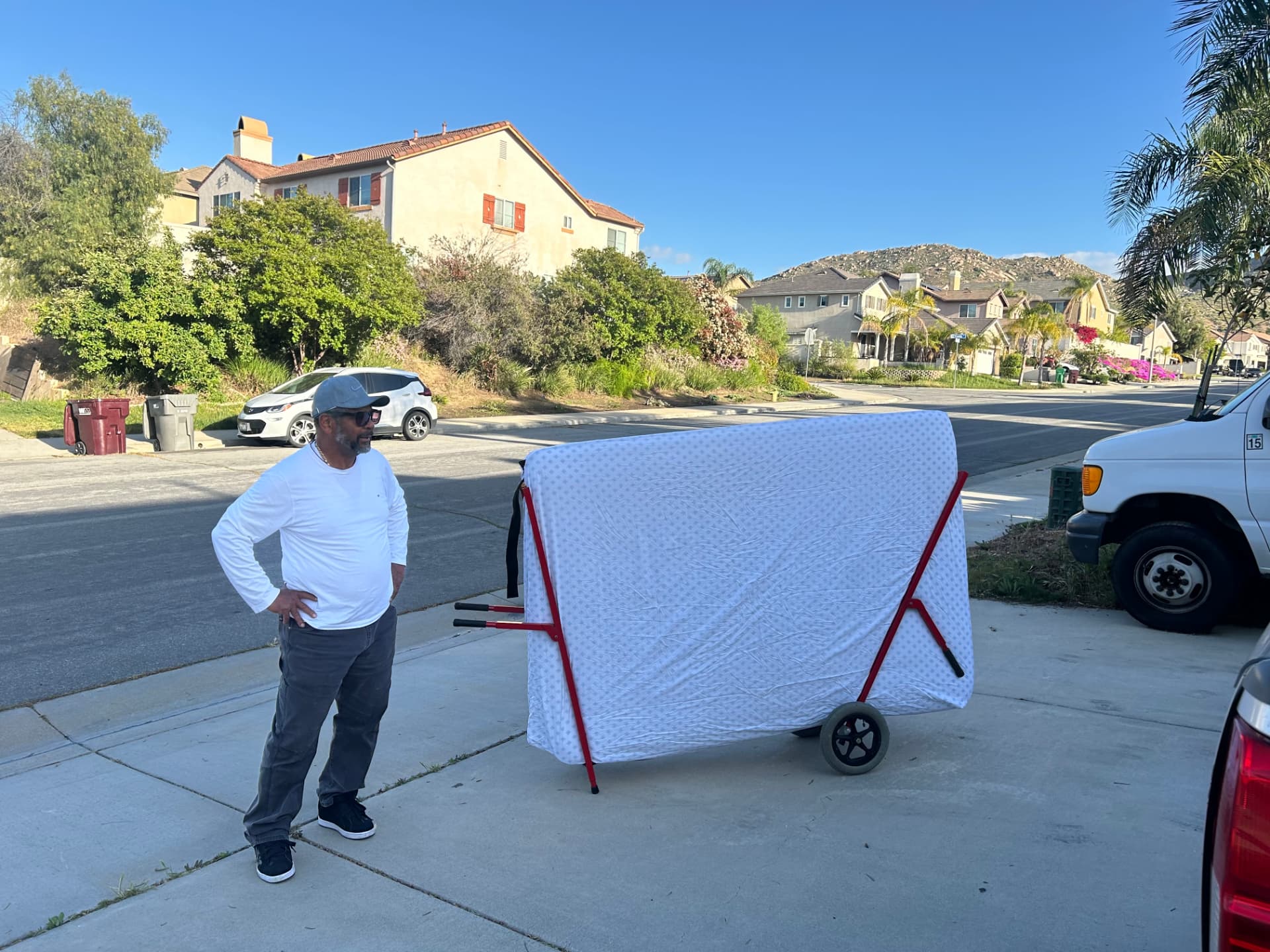 Mattress Buddy frame loaded with a mattress in a driveway